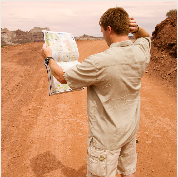 Man reading a map in the desert representing the CCC coaching program